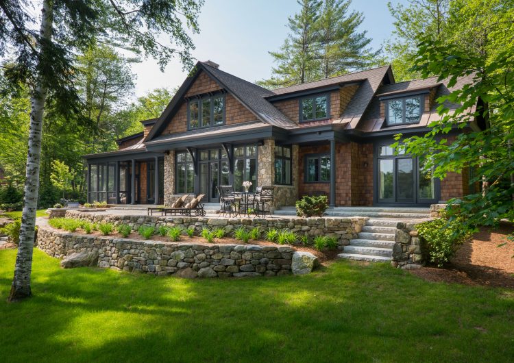 Situated in, New London NH, this design-build features a great room leading to a patio overlooking Lake Sunapee,